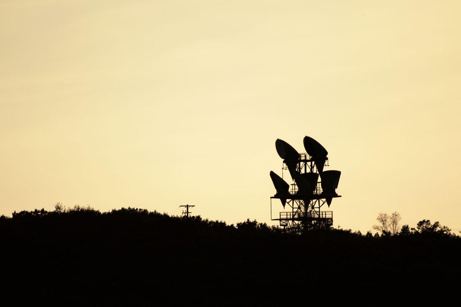 The Scranton Long Lines tower silhouetted in the sunset. These towers carried long distance telephone calls before copper and fiber covered the country. This was shot with a super-telephoto lens from the top of an adjacent mountain.