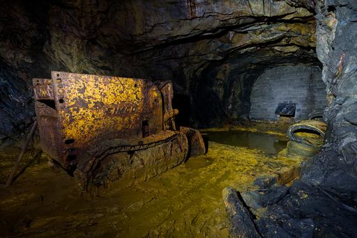 This EIMCO mucker sits abandoned deep in a coal mine. A mucker is a special type of excavator/bulldozer that scoops mud and launches it directly backwards over itself. These are especially common in underground mining where space is tight. The particular mine this machine was found in was filled with ridiculous amounts of mud, so it makes a lot of sense to find it here.