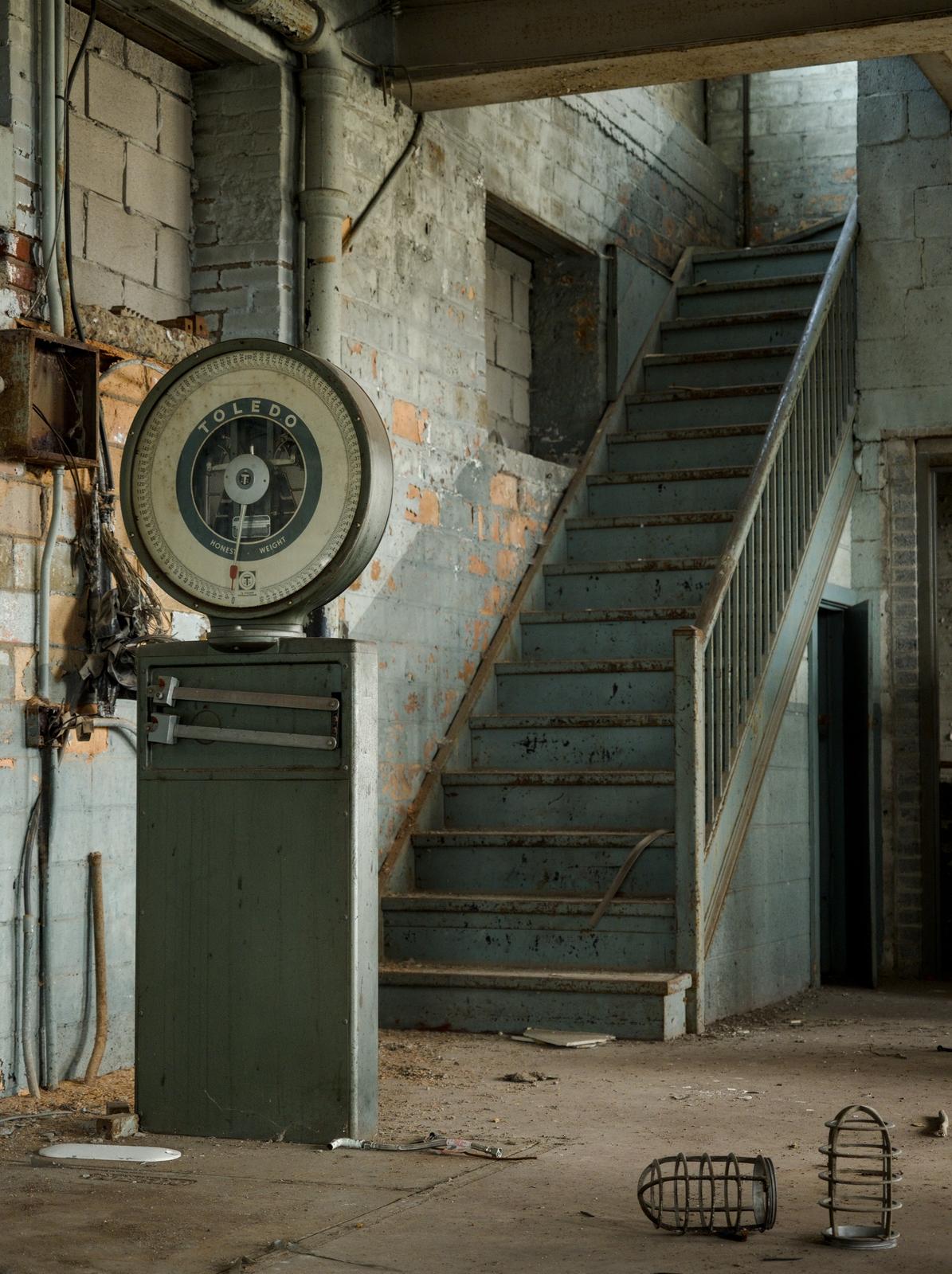 A working Toledo Scale sits still in an abandoned hospital power plant.
